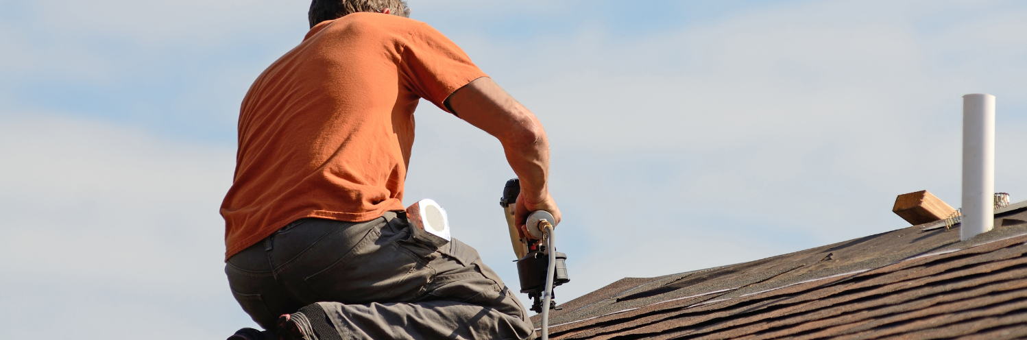 roofing contractor nailing down shingles
